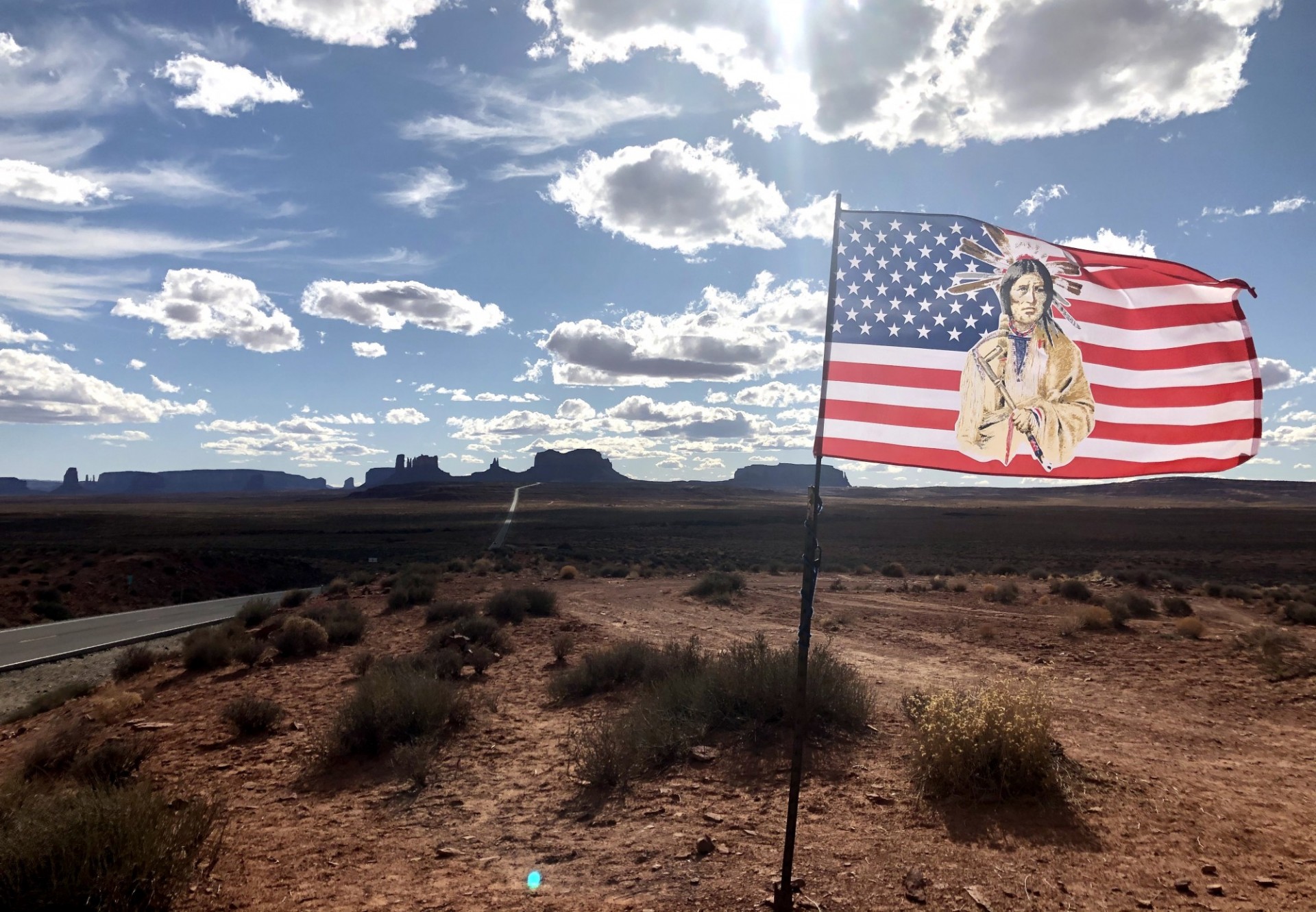 Flag flying with Monument Valley visible on the horizon 