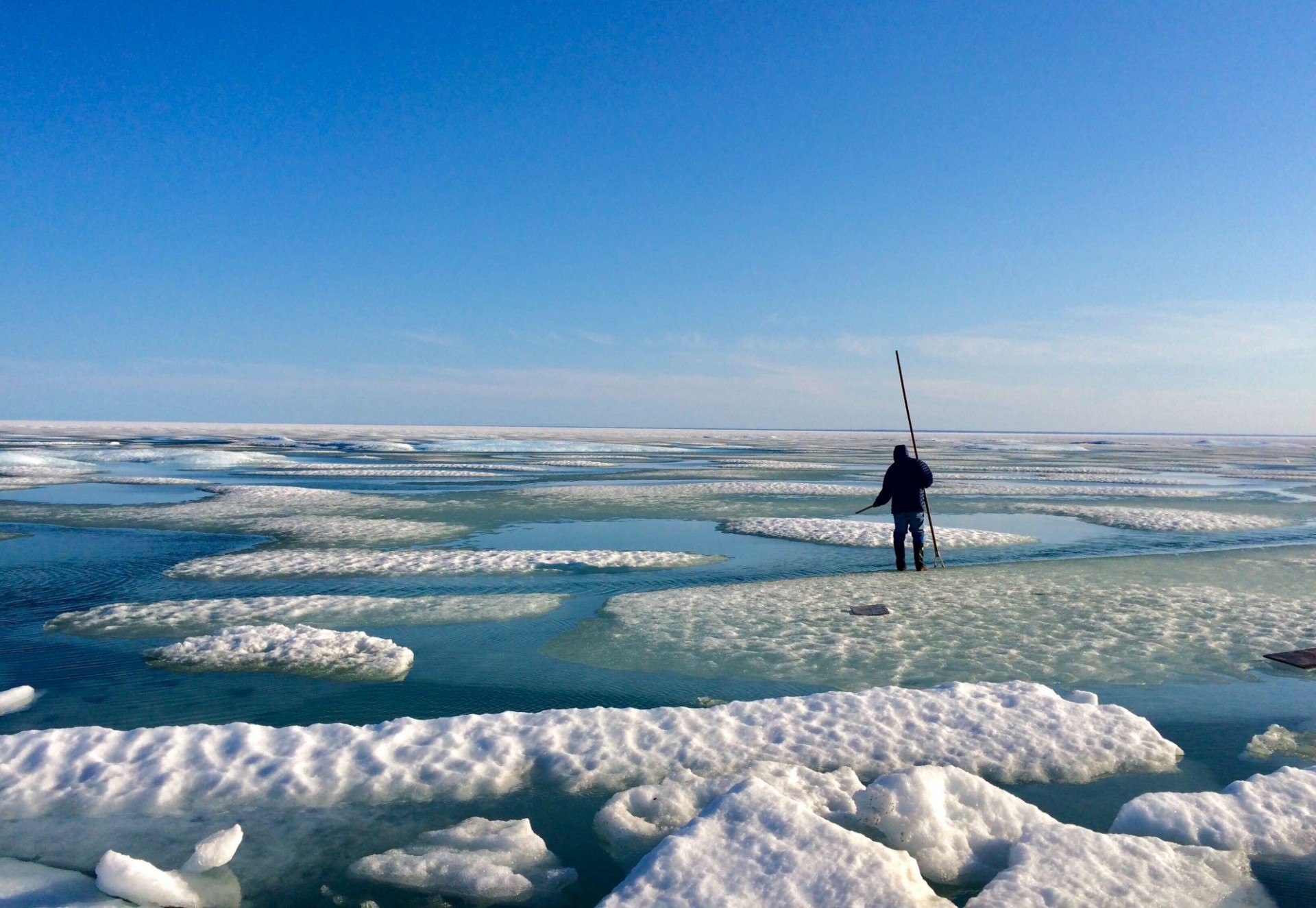 A person ice fishing in the North-West passage near Cambridge Bay, Nunavut